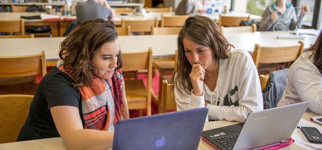 two female students studying in library