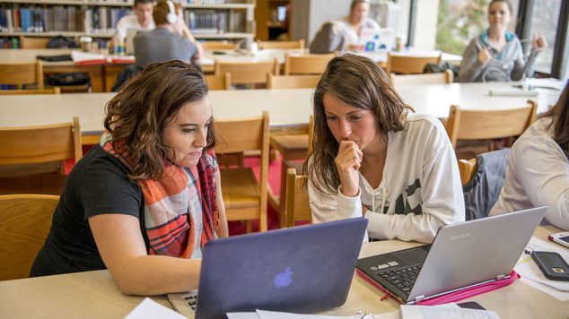 two female students studying in library