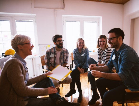 group of people sitting in chairs in a circle