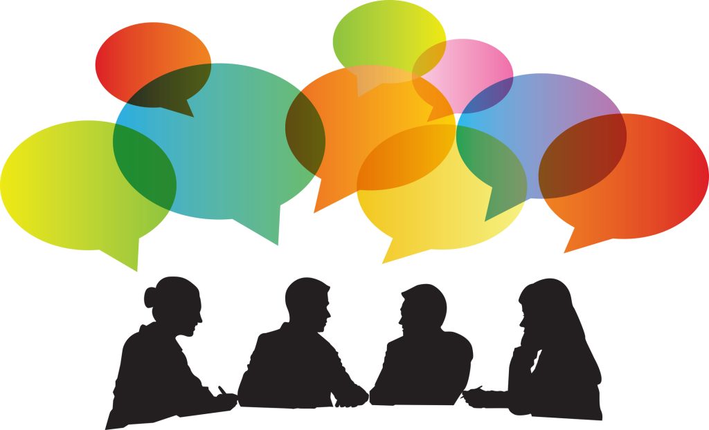 silhouettes of four people meeting with multi-colored talking bubbles above