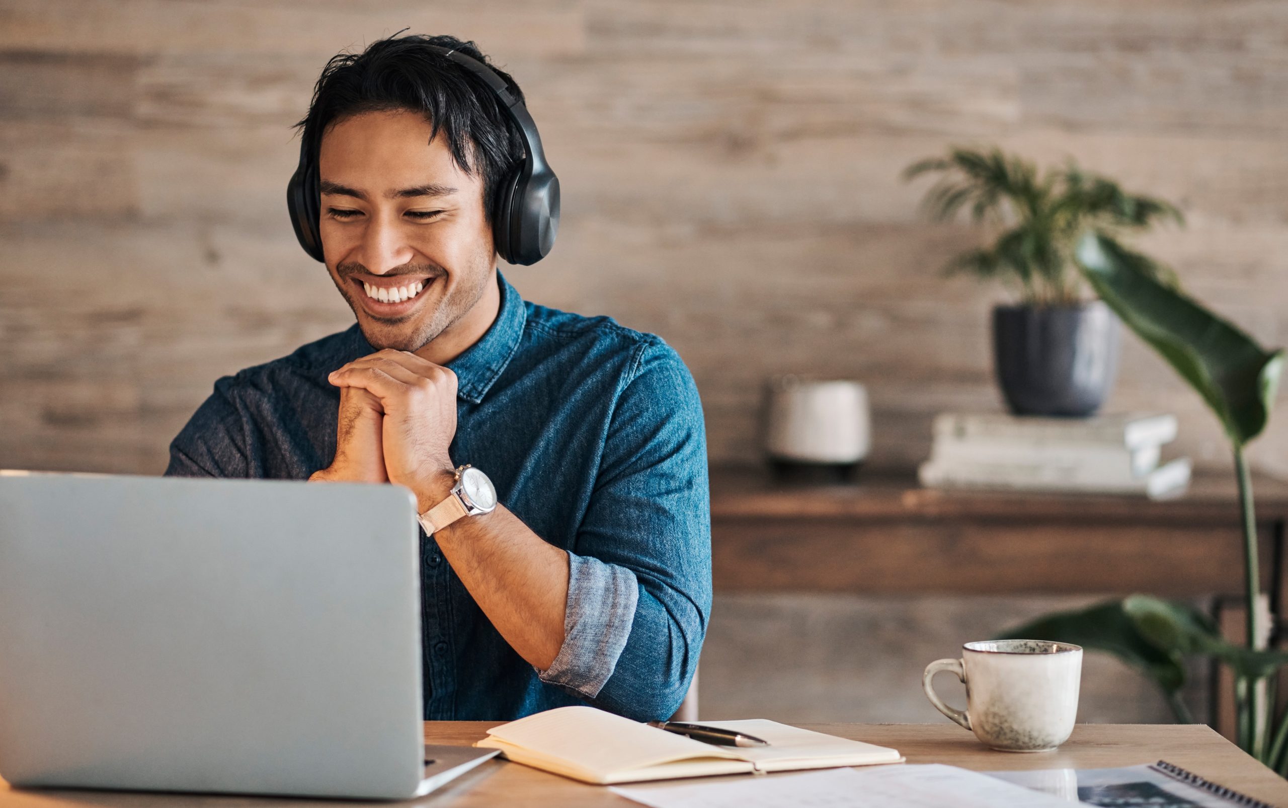 Person smiling while looking at a laptop