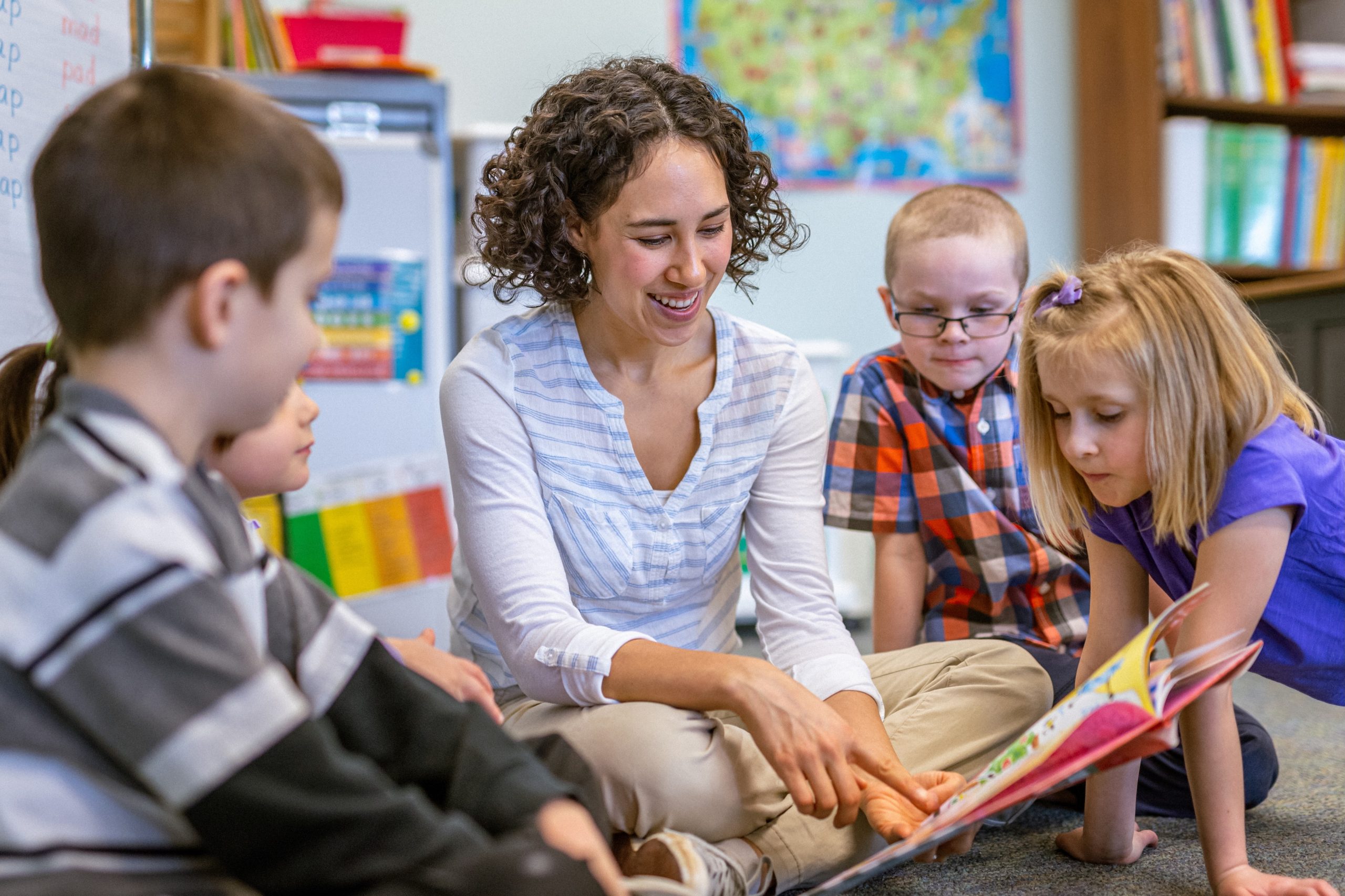 A teacher and young students in a classroom