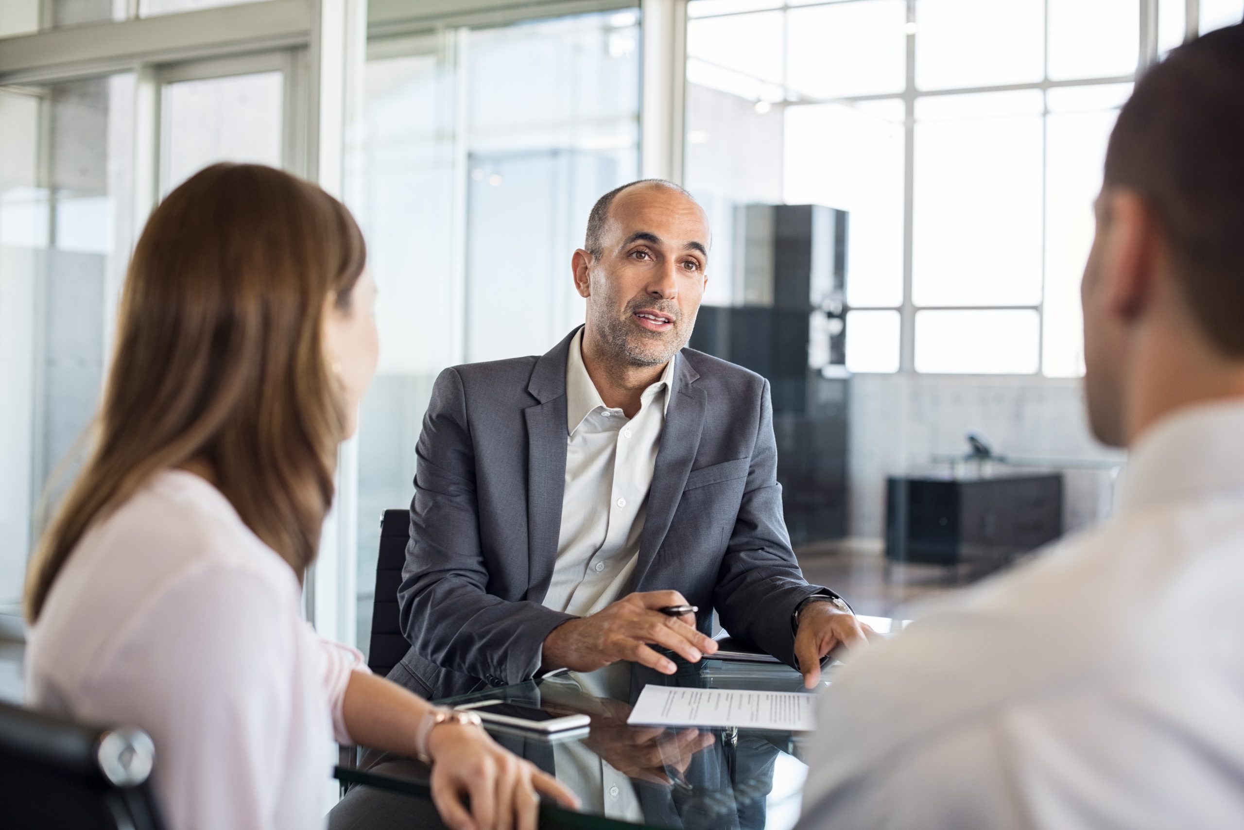 A manager talking to two employees