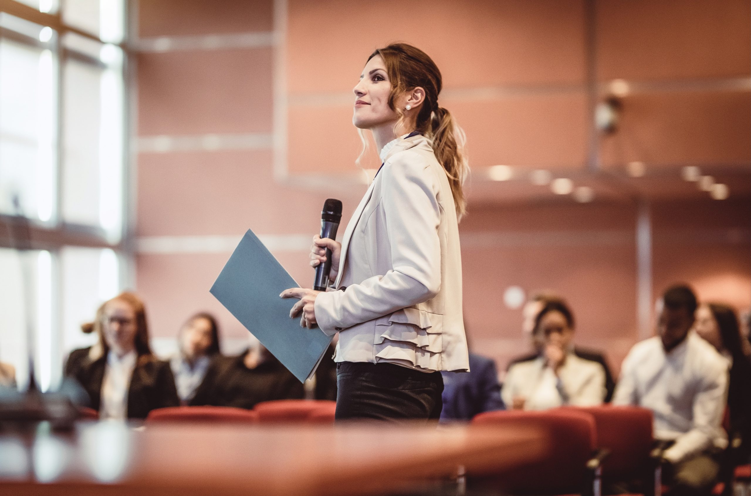 Person speaking in front of a crowd